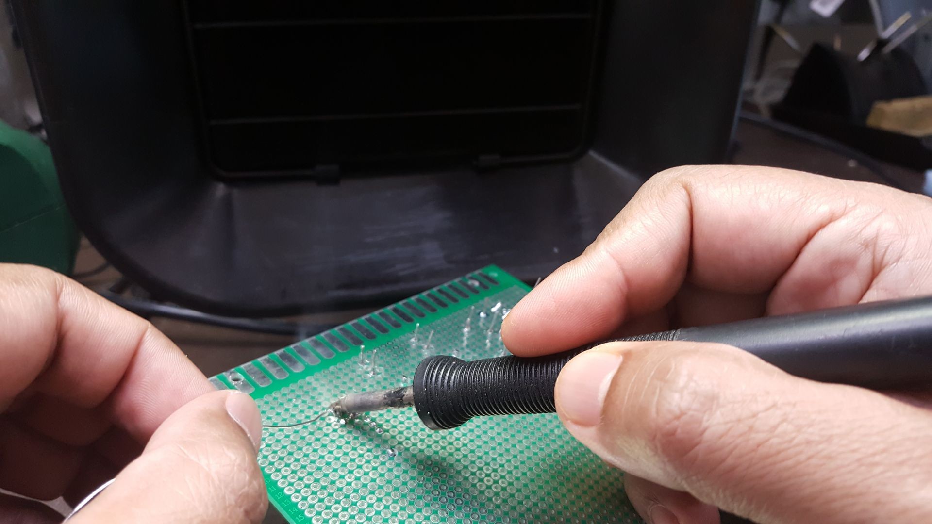 Soldering work in progress. Engineering project. Using smoke absober during the process for the health and safety awareness. Soldering work in progress. Engineering project. Using smoke absober during the process for the health and safety awareness.